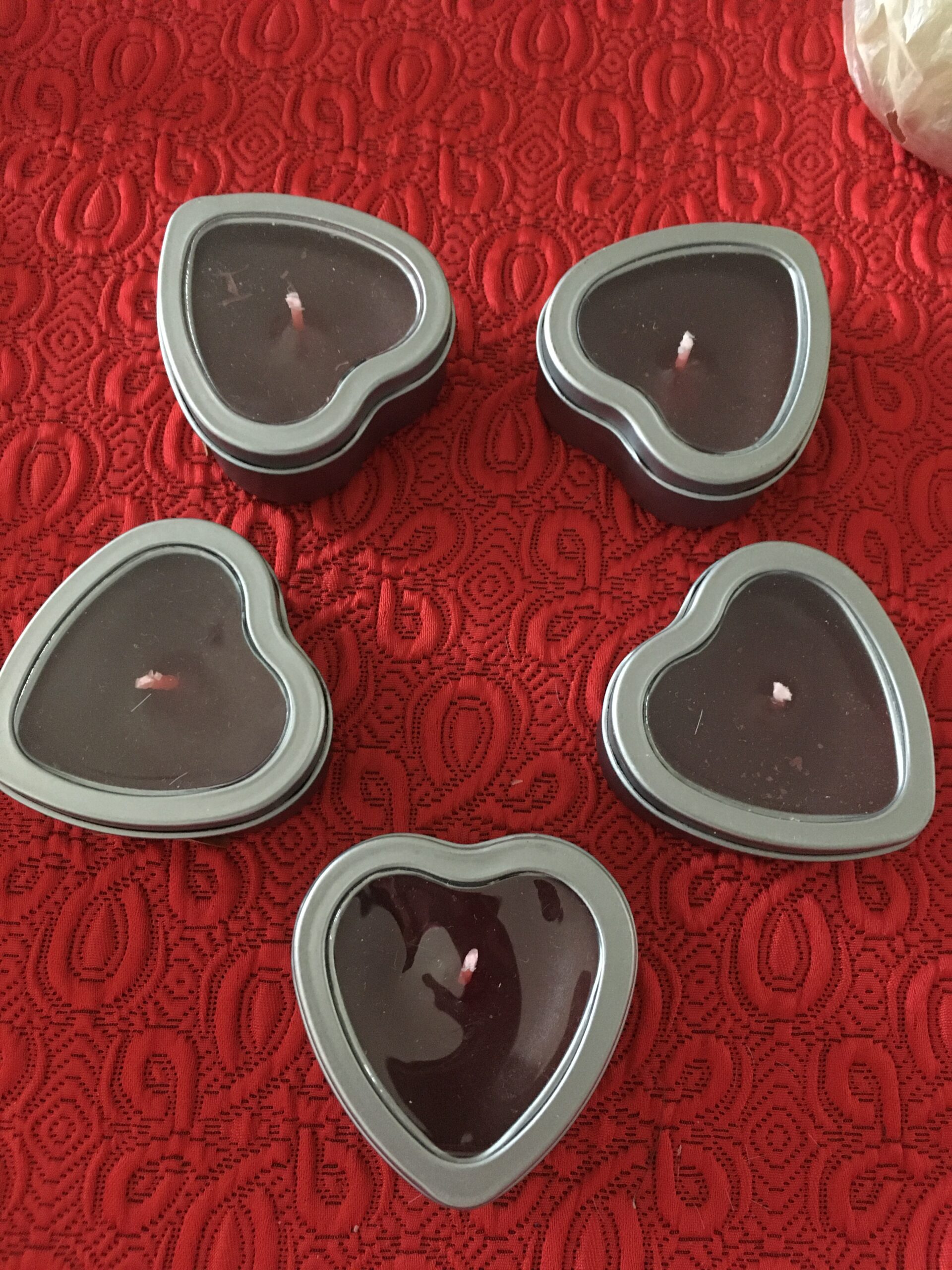 Bougies en forme de cœur dans des boîtes métalliques